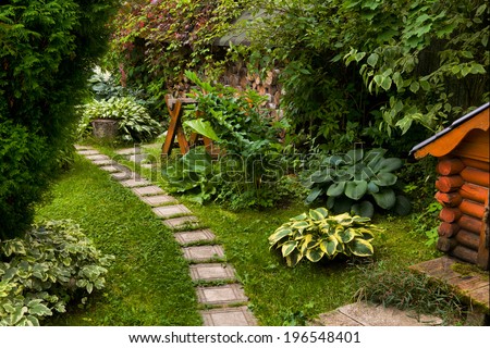 Green lawn in a colorful landscaped formal garden. Beautiful Garden.