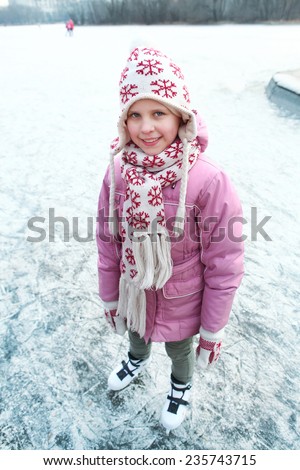 beautiful happy preteen girl figure skating in open winter ice skating rink