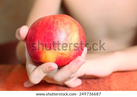 boys hand hold a red big apple