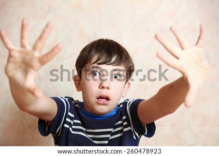 boy close up photo show fear emotion with hand gesture