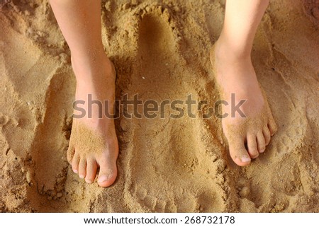 kids foot on the beach sand as a therapy against patypodia
