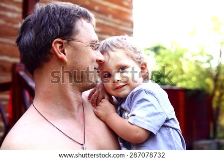 handsome baby boy with his dad clothe up portrait on the summer country mansion house background