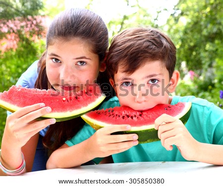 cute   siblings couple with water melon slices