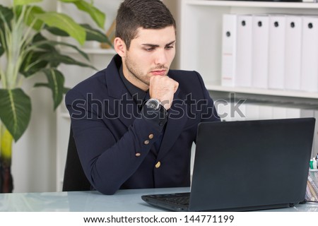 worried business man looking at laptop