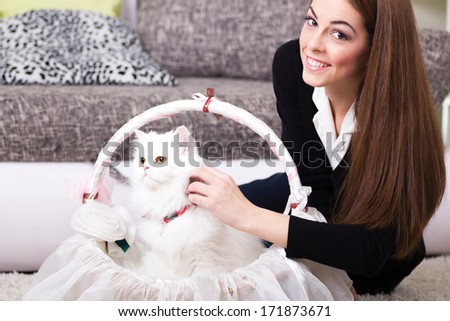 young girl and a white Persian cat in the house