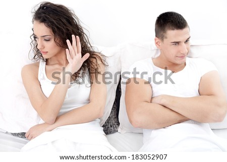unhappy young  couple in bedroom under stress