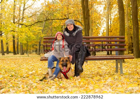 mother and son with dog in park