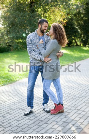 embraced  young couple in the park