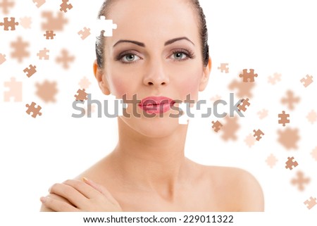 Beauty concept of a beautiful woman with puzzle pieces in the face.