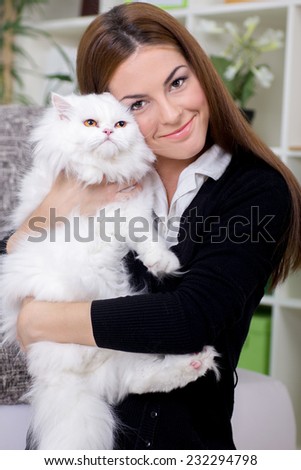 beautiful young woman holding a Persian cat