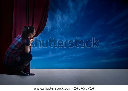 young woman in magic scene open curtain