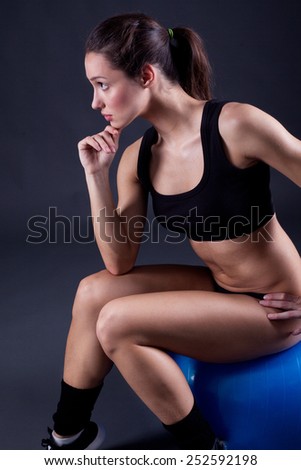sexy young fit woman siting on fit ball