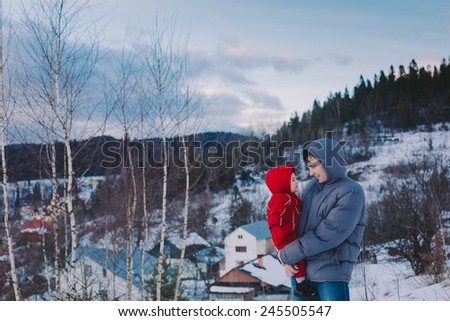 Family on winter mountain background. Carpathian mountains, Western Ukraine