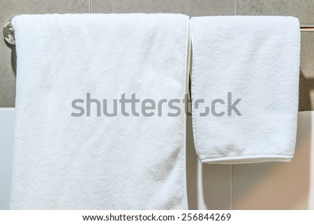 Bathroom Towel -  white towel on a hanger prepared to use