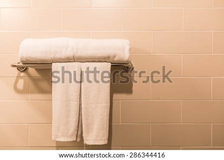 Bathroom Towel - white towel on a hanger prepared to use
