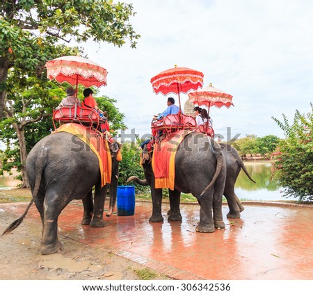 AYUTTHAYA, THAILAND - JULY 25: Tourists on an elephant ride tour of the ancient city on July 1, 2015 in Ayutthaya.