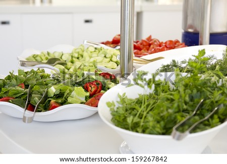 Buffet style salad in trays at restaurant. Fresh, healthy food.