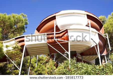 Colorful water slide in water park. Bright aqua park constructions in swimming pool