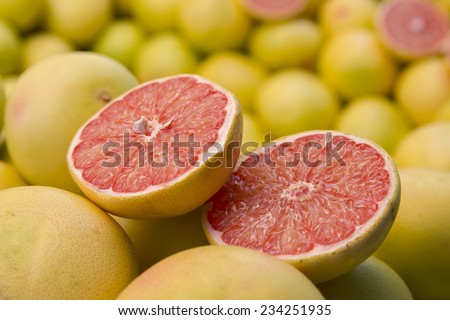 Fresh red grapefruit slices closeup, fruit background. Grapefruits on market for sale. background, wallpaper.