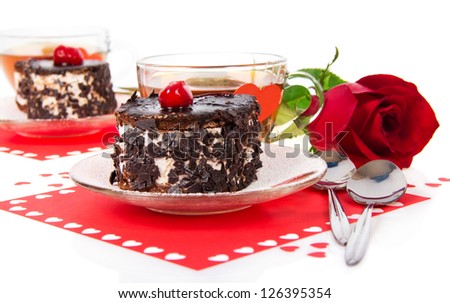 Romantic tea drinking in Valentine\'s day with chocolate cakes and red rose isolated on white