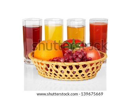 Set of juice in glasses and fruit, vegetables in a basket, isolated on white
