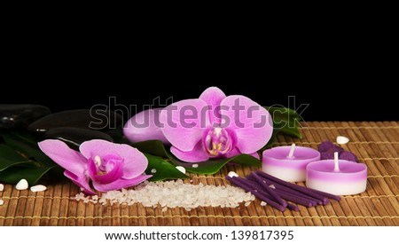 Orchid flowers, set for Spa on the bamboo cloth, isolated on black