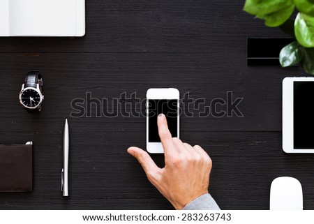 Blank modern digital tablet on a wooden desk. Top view. Great for your copy space. Gadgets on a wooden desk background. View from above.