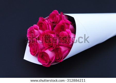Bouquet of roses on a black background. Greeting template background for greeting card, gift, present