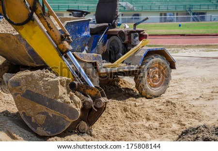 Excavator during earth moving works outdoors at sand quarry,Thailand