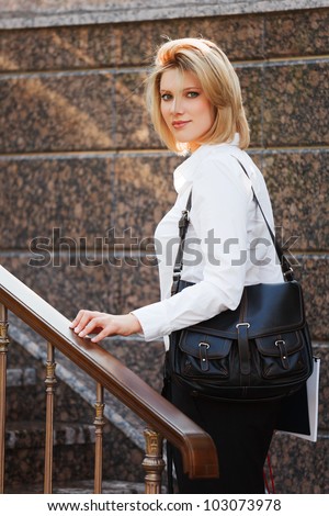 Young businesswoman on the steps