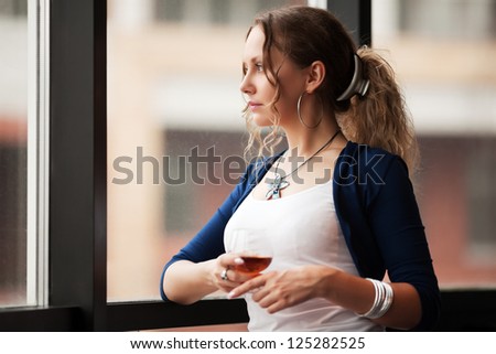 Beautiful young woman looking out the window