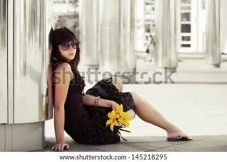 Sad young woman with flowers
