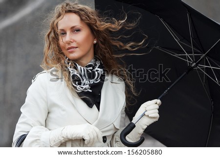 Woman with umbrella in the wind