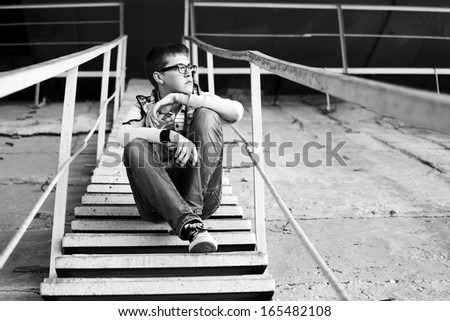 Young man in depression sitting on the steps
