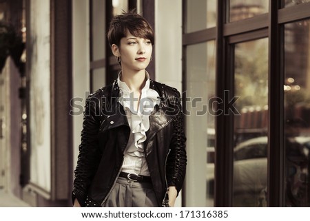 Young fashionable woman in leather jacket