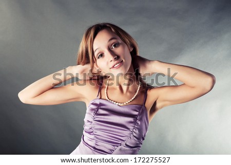Happy young woman in a lilac dress