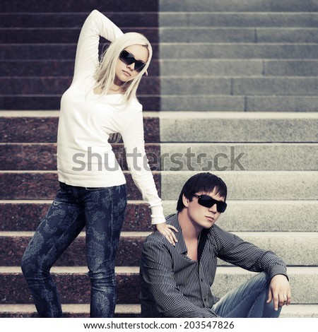 Young fashion man and woman on the steps