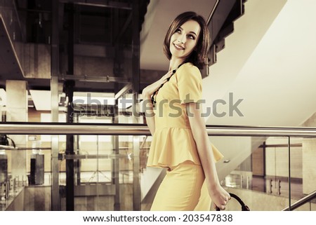 Happy young fashion business woman in office interior
