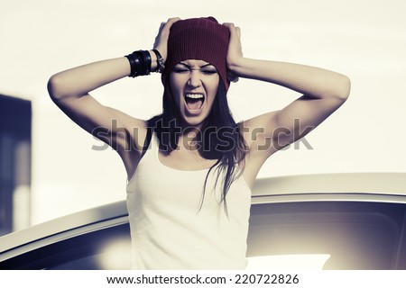 Angry fashion woman shouting at the car