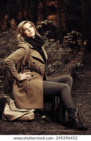 Happy young fashion woman in autumn forest