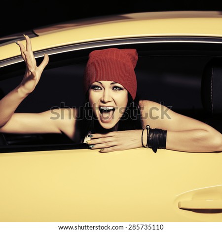 Angry fashion woman shouting in a car