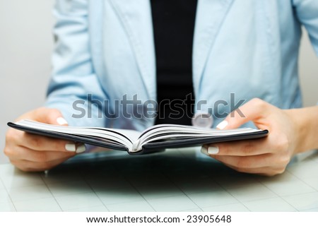 Businesswoman reading the accounting ledger.
