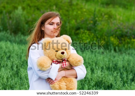 Sad young woman with a toy.