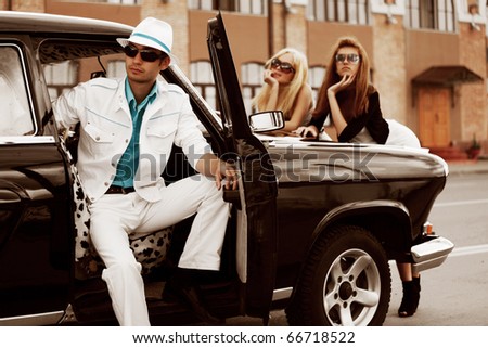 Young people with a retro car.