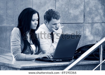 Young couple with laptop.