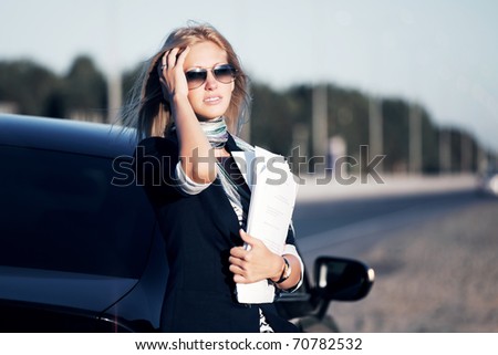 Young businesswoman against a highway