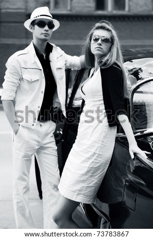 stock-photo-young-couple-against-retro-car-73783867.jpg