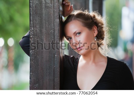 Beautiful young woman on the porch