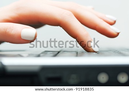Female hand typing on computer keyboard