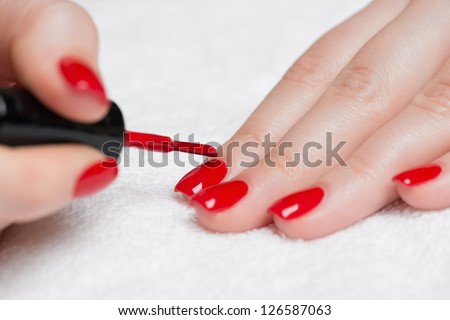Manicure - Beauty treatment photo of nice manicured woman fingernails with red nail polish.